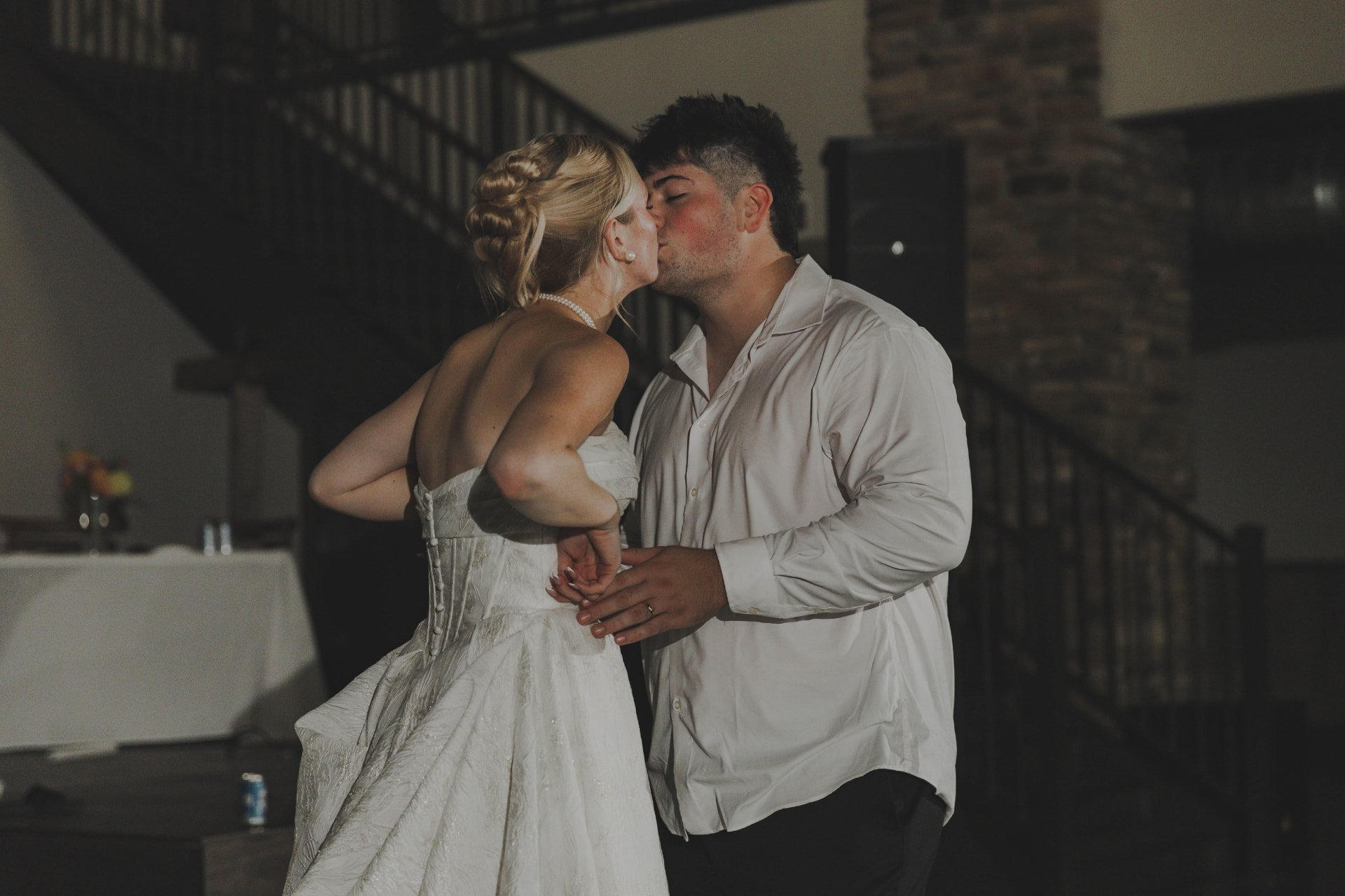 Newlyweds kissing during their first dance at a Columbia MO wedding reception